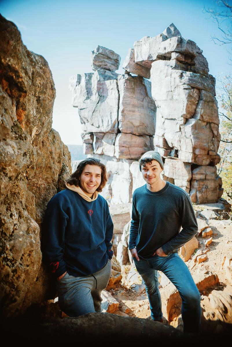Two young men outdoors among rocks